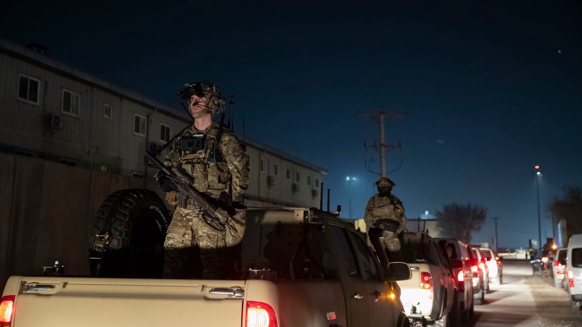 FILE - In this Nov. 28, 2019 file photo, armed soldiers stand guard in the motorcade for...