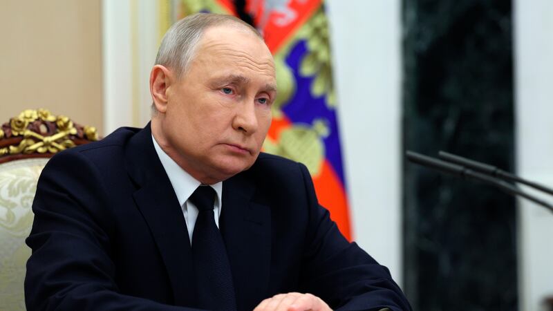 Russian President Vladimir Putin listens to Russian Transport Minister Vitaly Savelyev during...