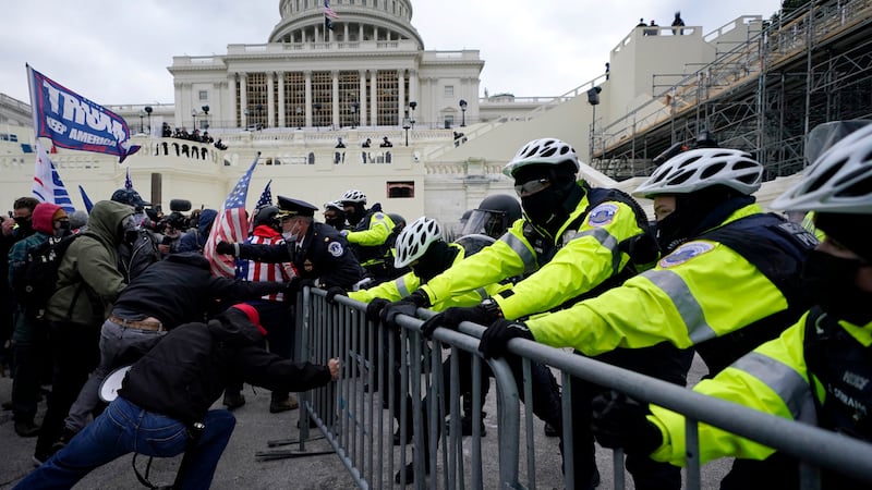 FILE - Supporters of President Donald Trump try to break through a police barrier, Wednesday,...