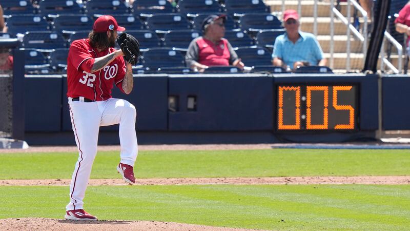 Washington Nationals starting pitcher Trevor Williams (32) winds up to throw as the pitch...